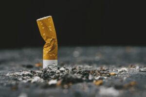 Cigarette butt.Closeup cigarette and cigarette butt on the floor.World No Tobacco Day Concept.